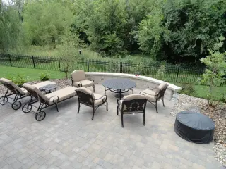 Beautiful outdoor patio with fire pit by Green Expectations Landscaping